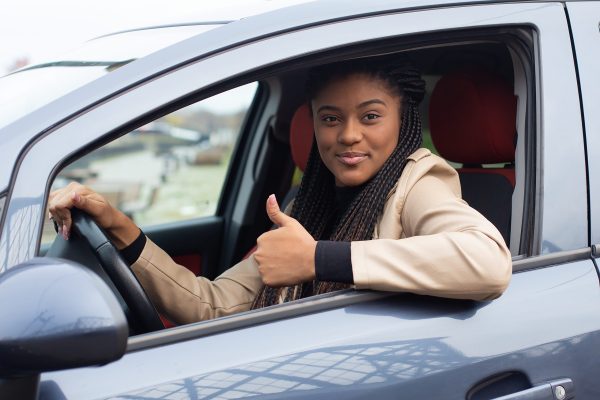 the Happy girl in a car driving, African American